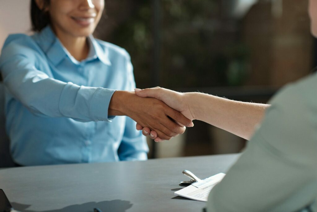 Employer greeting candidate at meeting